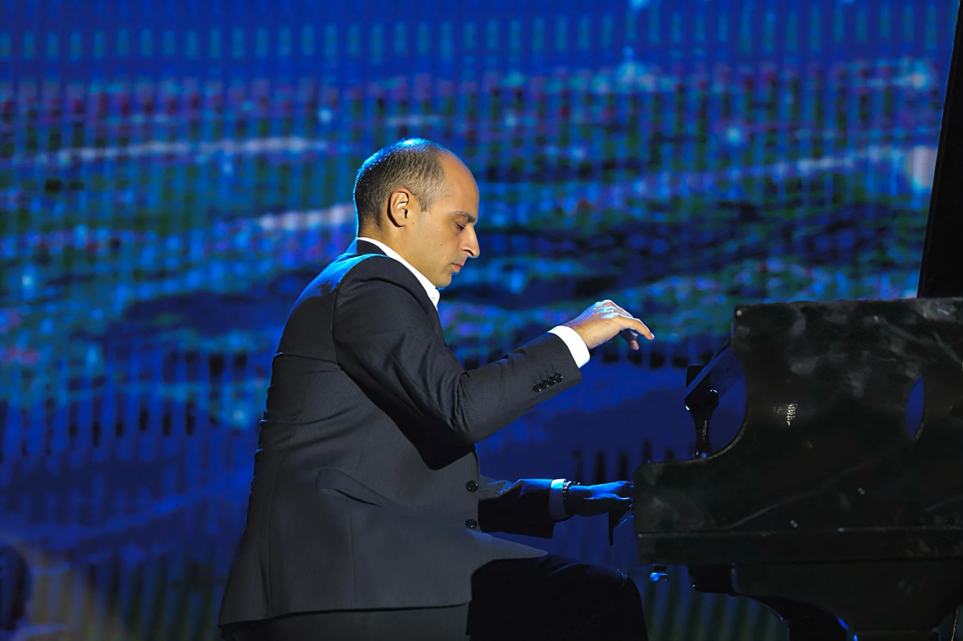 Ivan Yanakov performing on a blue-lit concert stage